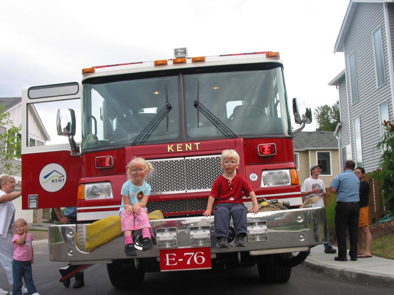 The face painted kids posing on the fire truck